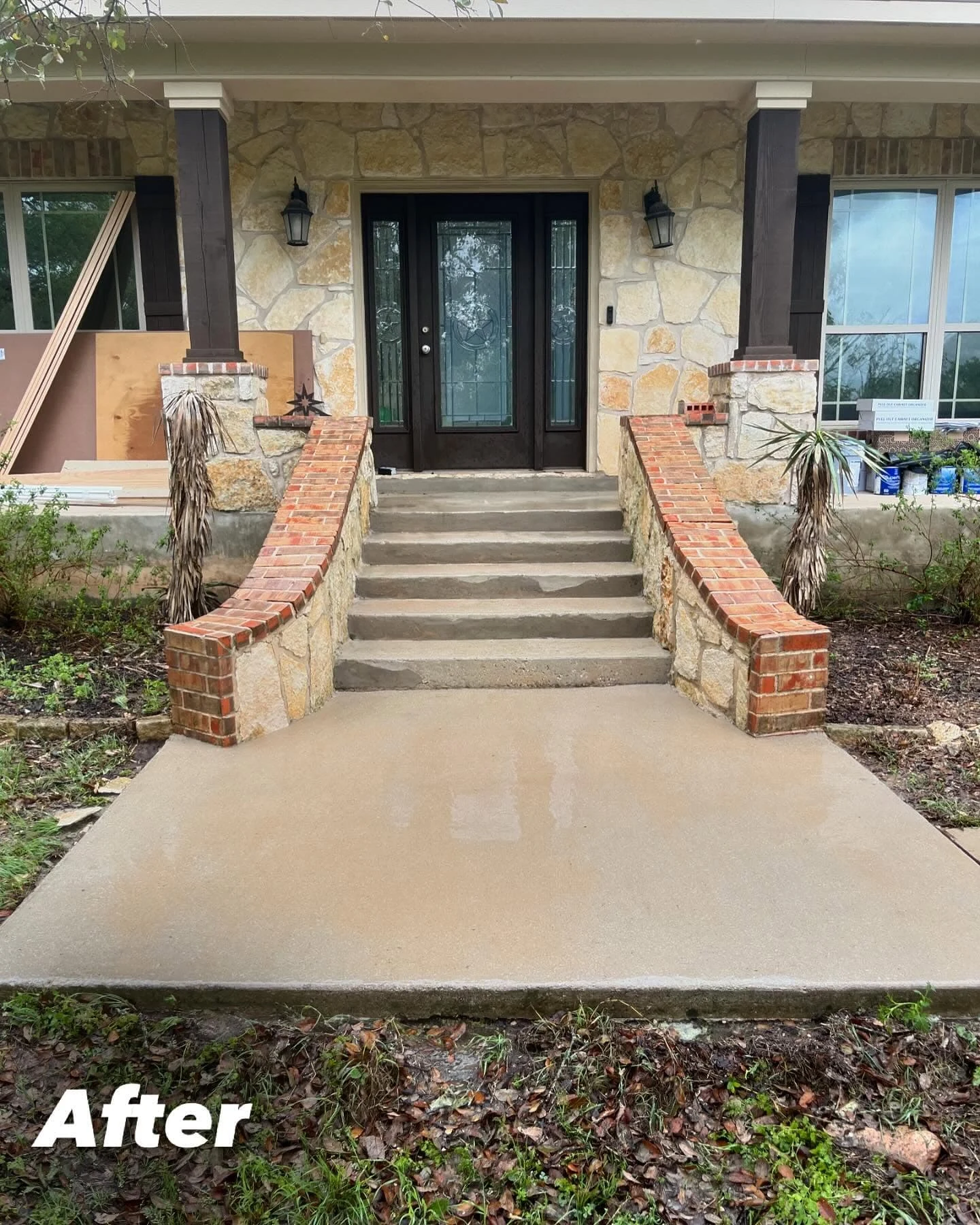 The same home's front steps and concrete entry path after cleaning