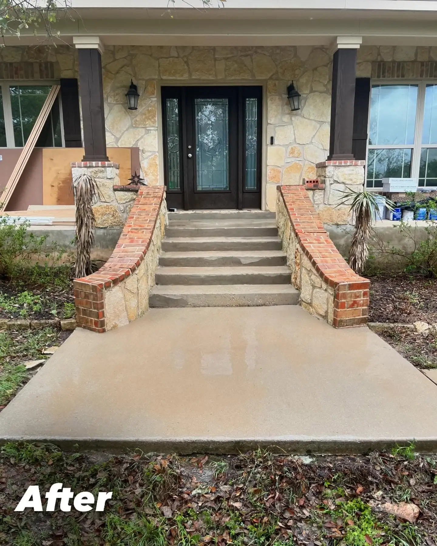 The same home's front steps and concrete entry path after cleaning